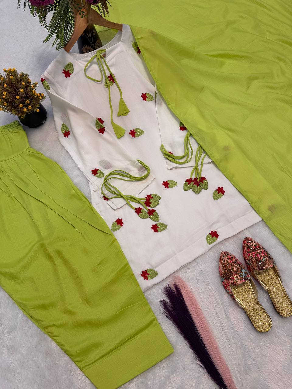Ethereal Ivory White Short Kurti Adorned with Delicate Floral Embroidery and Tassel Detailing, Paired with a Vibrant Mehendi Green Salwar